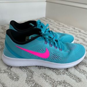Nike free running shoe in blue and hot pink combo. Only worn a couple of times!